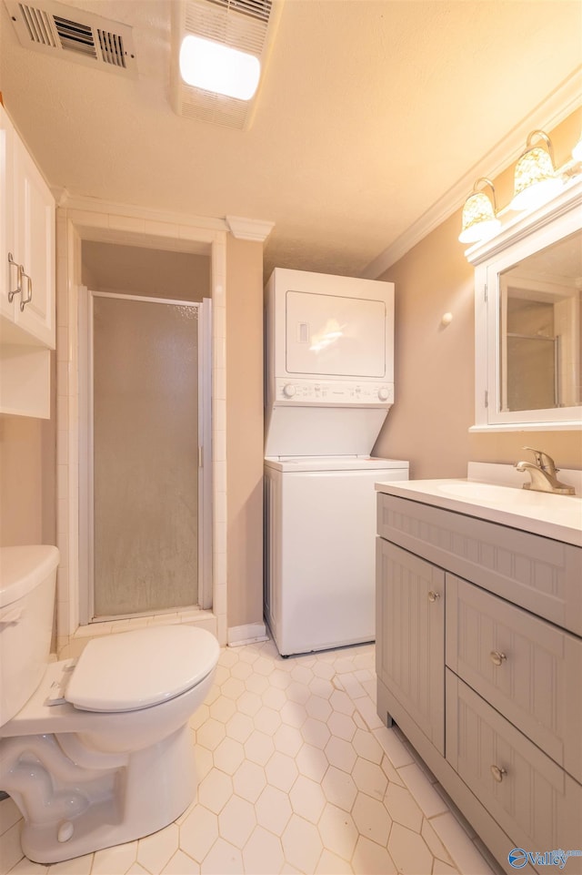 full bathroom with visible vents, toilet, ornamental molding, stacked washer / dryer, and a stall shower