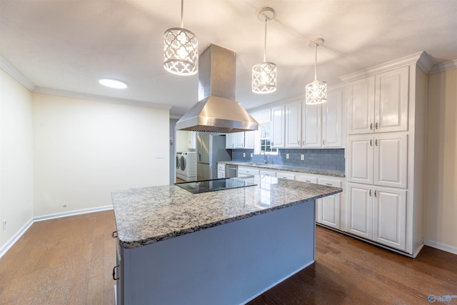 kitchen featuring washer / clothes dryer, white cabinets, a sink, and island range hood