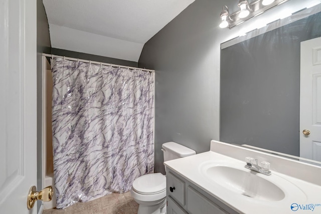 bathroom featuring vaulted ceiling, toilet, and vanity