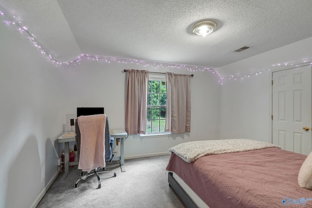 carpeted bedroom with a textured ceiling