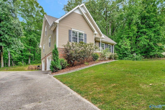 view of side of property with a garage and a lawn