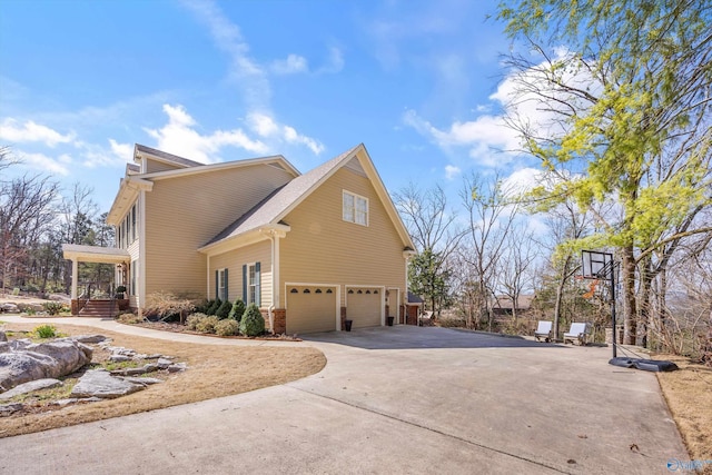 view of side of property with a garage, driveway, and brick siding