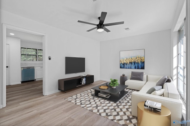 living room featuring light wood-type flooring and ceiling fan