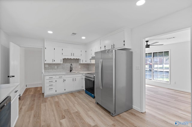 kitchen featuring ceiling fan, stainless steel appliances, sink, light hardwood / wood-style floors, and white cabinetry