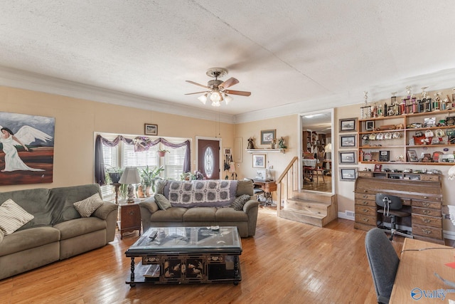 living room with a textured ceiling and light hardwood / wood-style floors