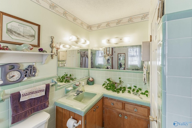 bathroom with vanity, a textured ceiling, and toilet