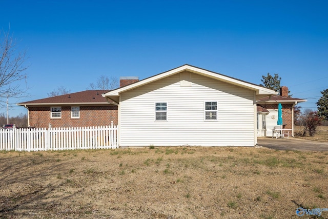 view of side of home with a lawn