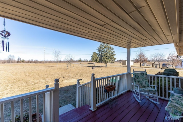 wooden deck with a rural view