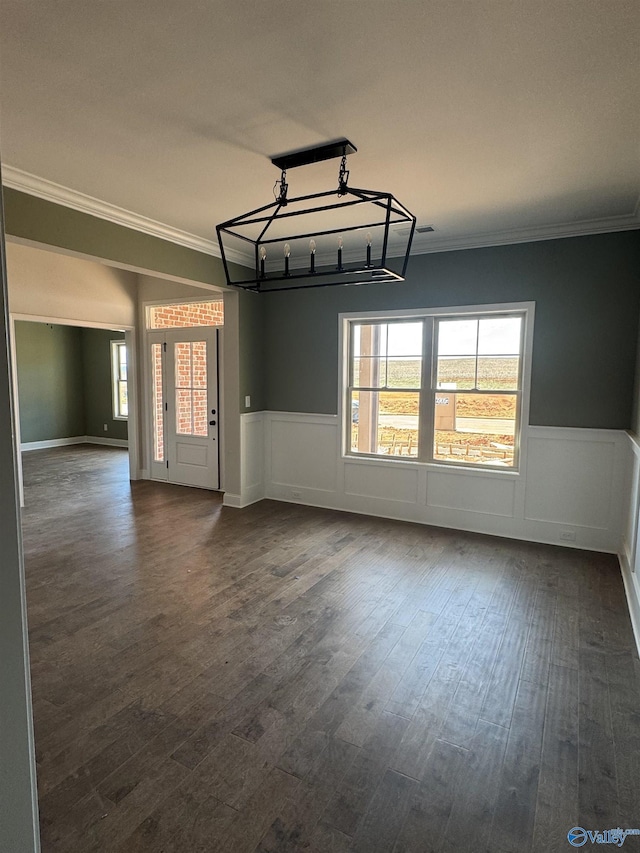 unfurnished room with dark wood finished floors, wainscoting, and crown molding