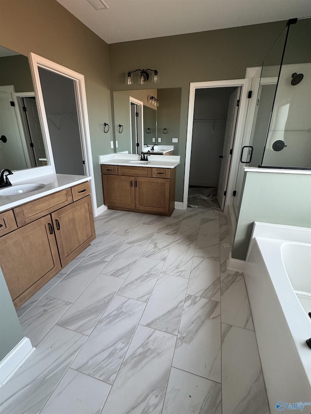 full bath with marble finish floor, a sink, and a shower stall