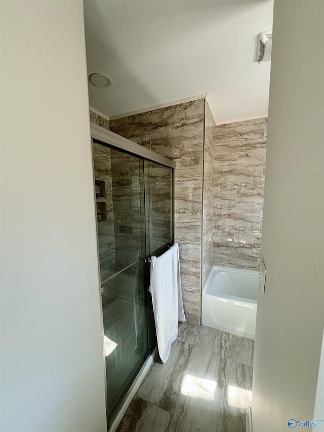 full bath featuring a bathing tub and a shower stall