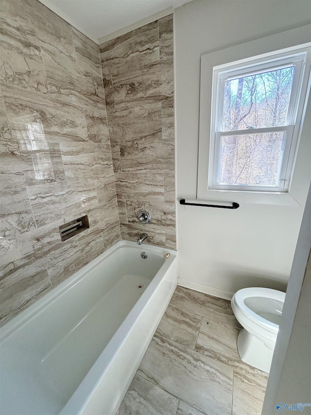 bathroom with toilet and baseboards