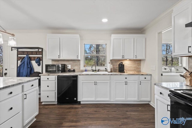 kitchen featuring independent washer and dryer, black appliances, ornamental molding, and a sink