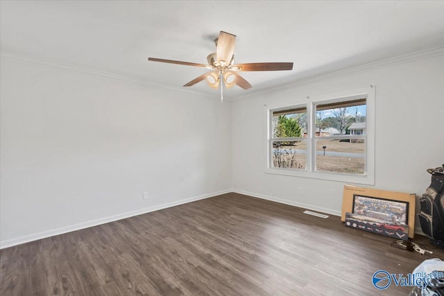 interior space with baseboards, a ceiling fan, wood finished floors, and crown molding