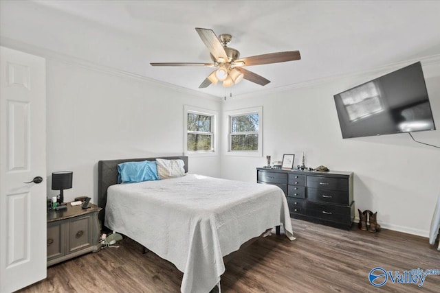 bedroom with baseboards, wood finished floors, a ceiling fan, and ornamental molding