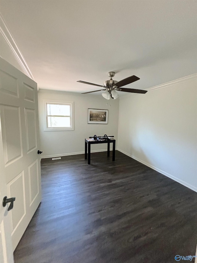 unfurnished room with ornamental molding, baseboards, dark wood-style flooring, and ceiling fan