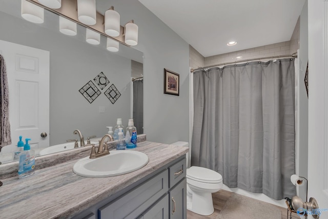 bathroom with a shower with curtain, toilet, vanity, and hardwood / wood-style flooring