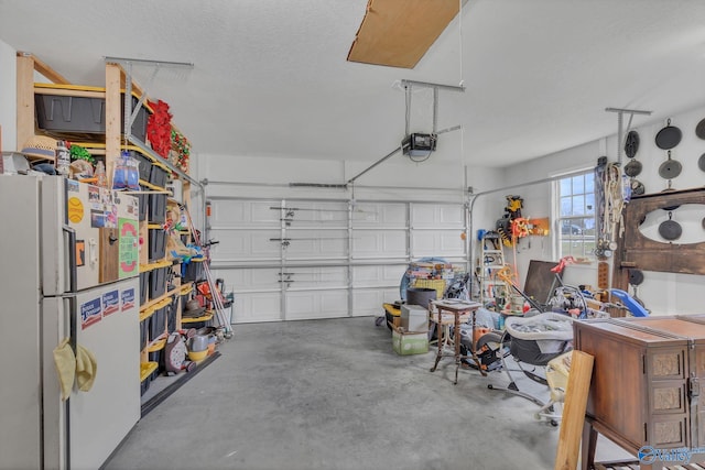 garage with white fridge and a garage door opener