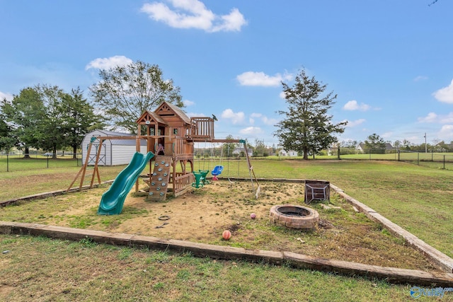 view of play area featuring a yard and a fire pit