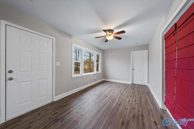 foyer featuring baseboards, dark wood-type flooring, and ceiling fan