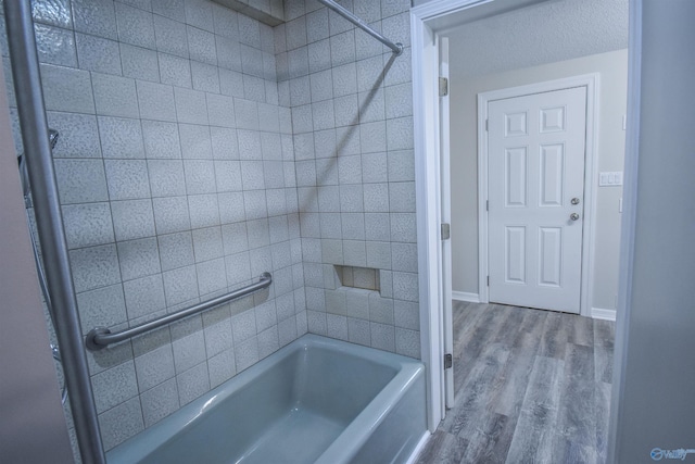 full bathroom with shower / washtub combination, baseboards, and wood finished floors