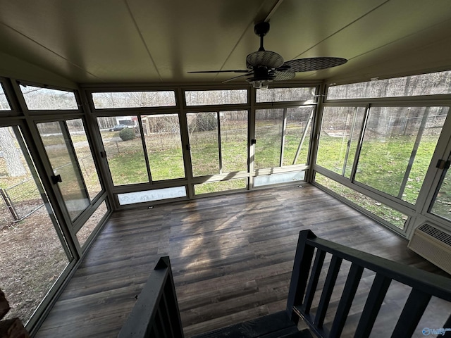 unfurnished sunroom with ceiling fan