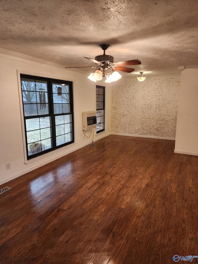 unfurnished living room with heating unit, crown molding, a textured ceiling, dark hardwood / wood-style flooring, and ceiling fan