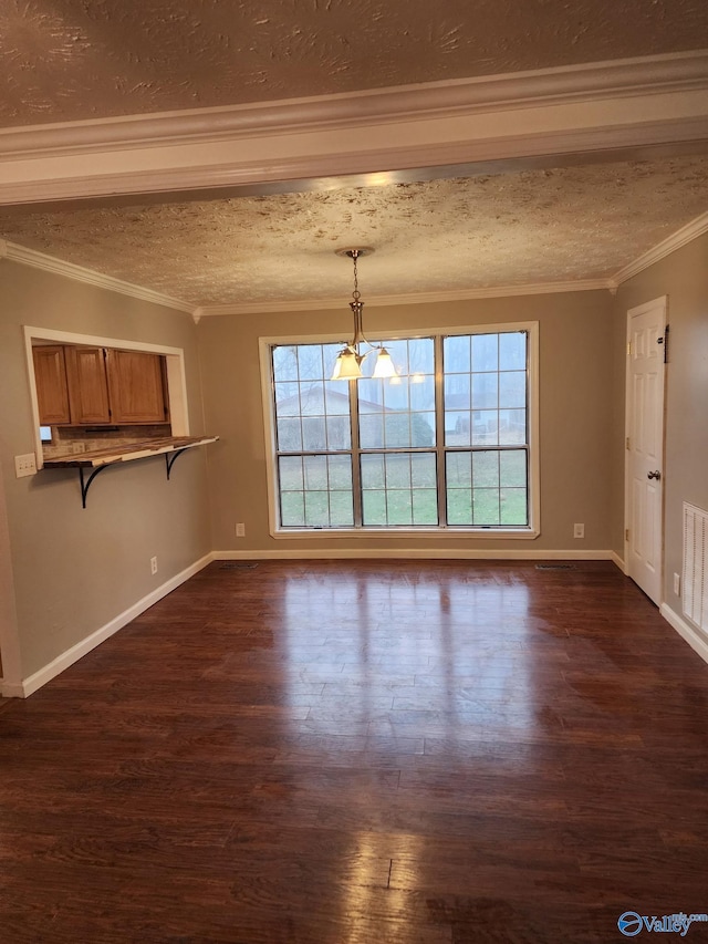 unfurnished living room with dark wood-type flooring, ornamental molding, an inviting chandelier, and a textured ceiling