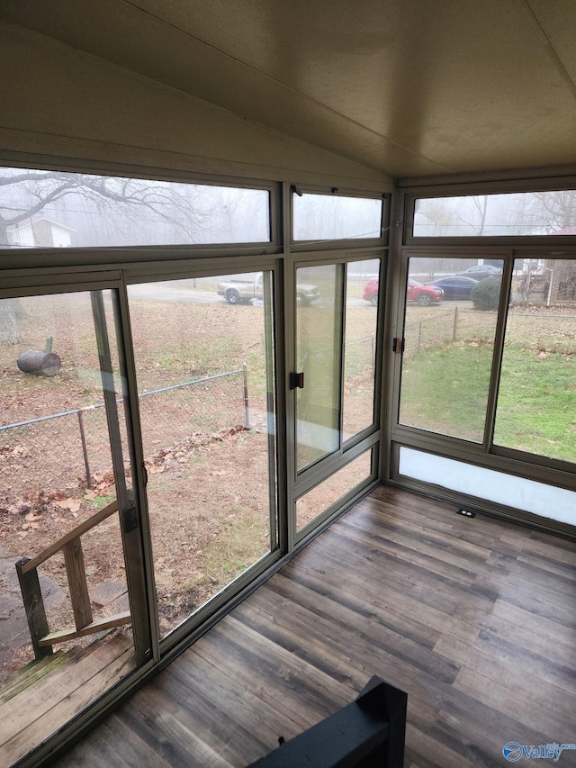 unfurnished sunroom with lofted ceiling
