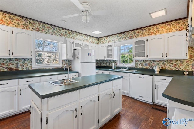 kitchen with white cabinets and white appliances