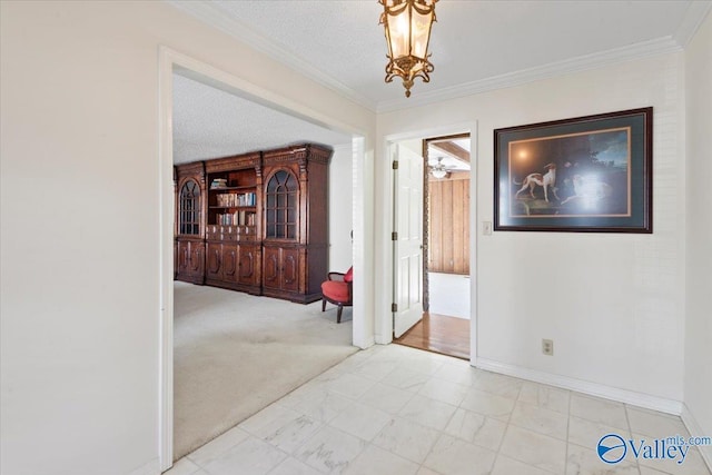 corridor with crown molding, light colored carpet, a textured ceiling, and a notable chandelier