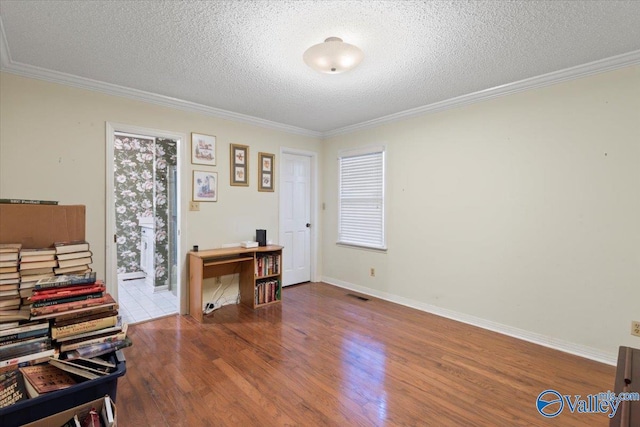 miscellaneous room featuring hardwood / wood-style flooring, crown molding, and a textured ceiling