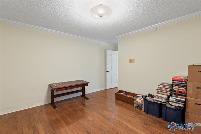 miscellaneous room with hardwood / wood-style flooring, crown molding, and a textured ceiling