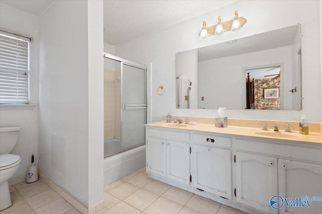 full bathroom with vanity, tile patterned flooring, toilet, enclosed tub / shower combo, and a textured ceiling