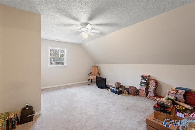 additional living space featuring ceiling fan, carpet floors, a textured ceiling, and lofted ceiling