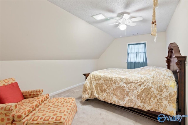 bedroom featuring lofted ceiling, ceiling fan, carpet, and a textured ceiling