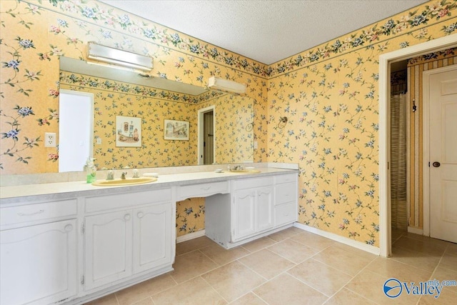 bathroom featuring tile patterned flooring, a textured ceiling, and vanity