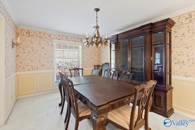 dining space featuring a notable chandelier, light colored carpet, and ornamental molding