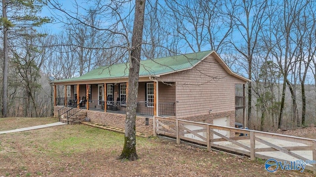 view of side of home featuring a porch and a garage