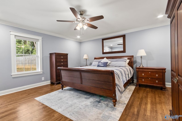 bedroom featuring crown molding, ceiling fan, and dark hardwood / wood-style floors