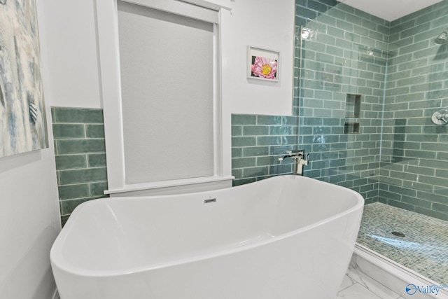 bathroom featuring tile walls and independent shower and bath