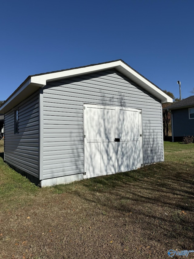 view of outbuilding featuring a lawn