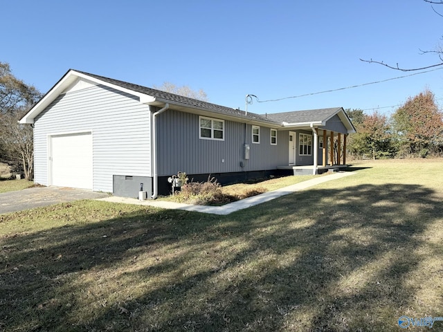 view of property exterior featuring a garage and a lawn