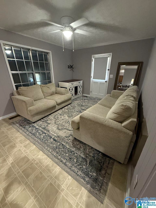 living room with a textured ceiling and ceiling fan