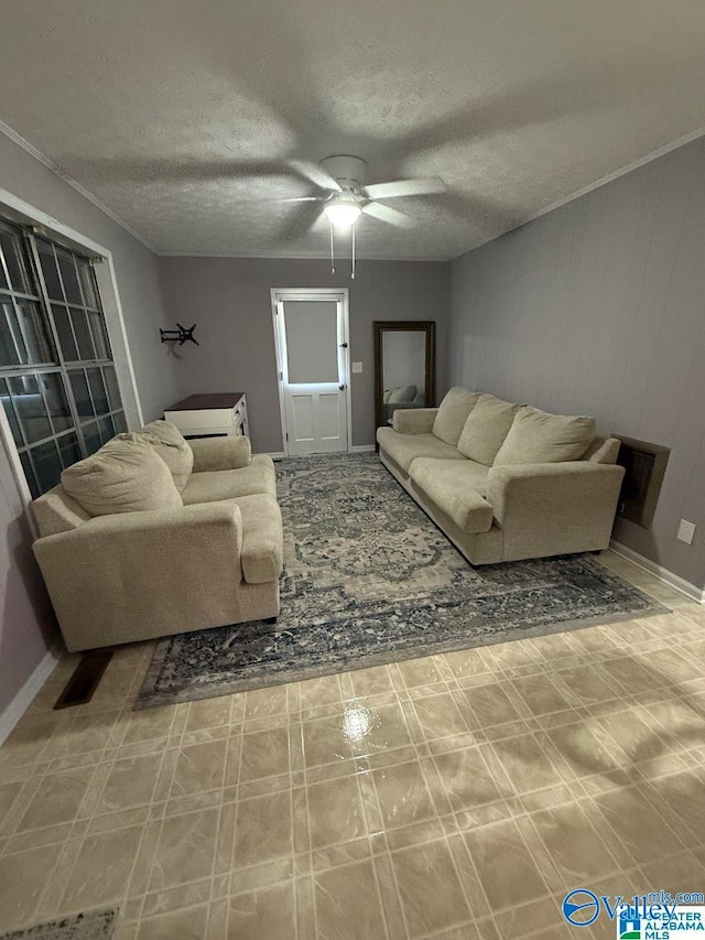 living room with a textured ceiling and ceiling fan