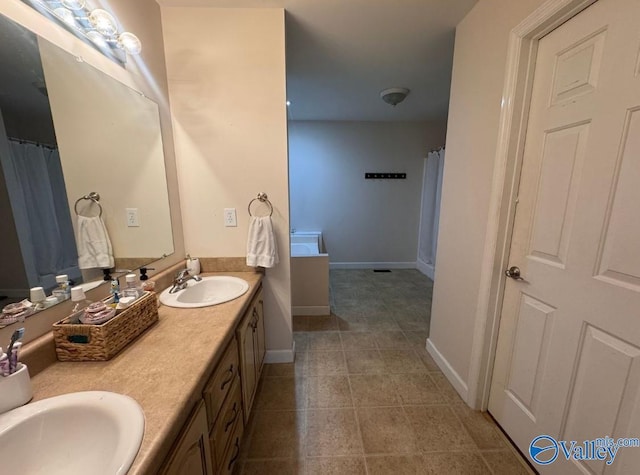 bathroom with tile patterned floors and vanity