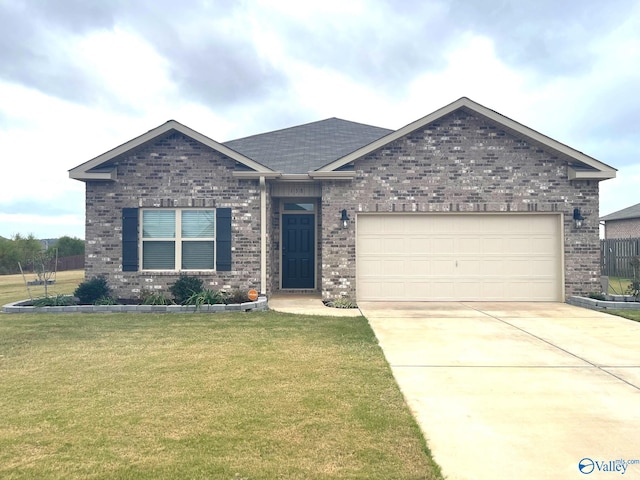 view of front of home with a front yard and a garage