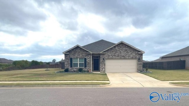 view of front of home featuring a front lawn and a garage