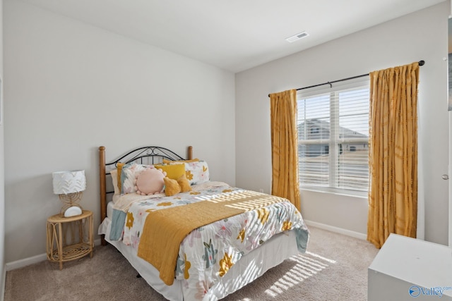 bedroom featuring light carpet