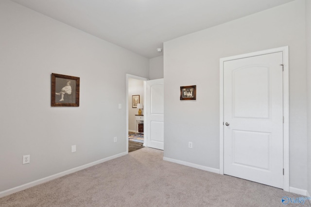 unfurnished bedroom featuring light carpet